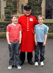 Chelsea Pensioner Staff Sergeant William 'Paddy' Fox is pictured talking to two young parishioners from Saint Patrick's parish after morning service on Sunday June 28.